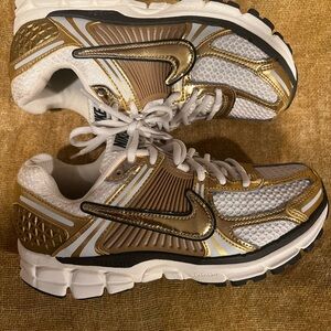 Sold out on NIKE website! Gold and white. Size womens 7.5
